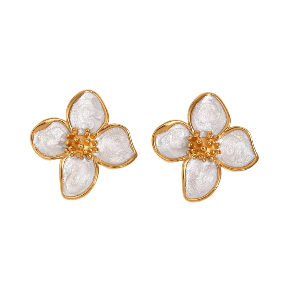 A pair of 18K gold coated floral earrings with white enamel petals.