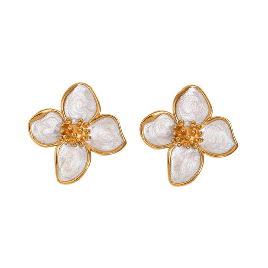 A pair of 18K gold coated floral earrings with white enamel petals.