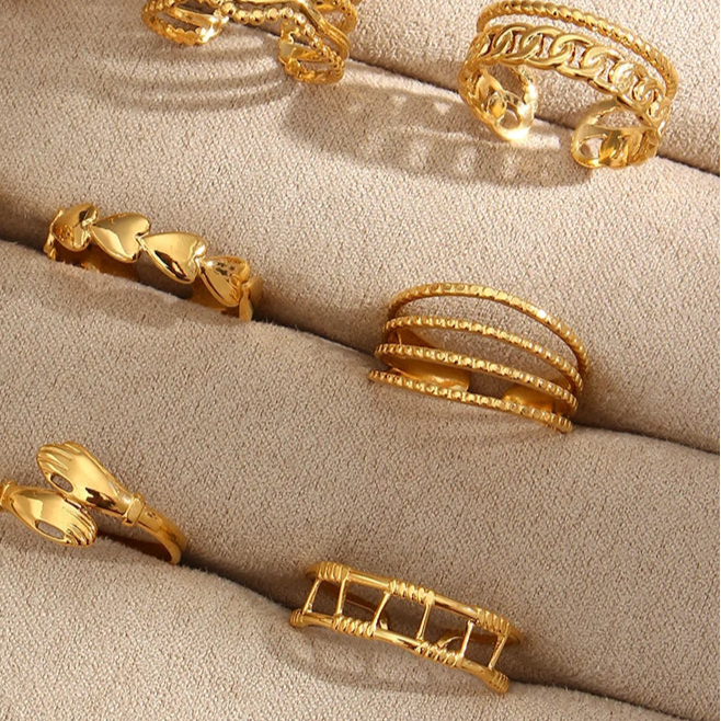 A gold-coated stainless steel ring with four bands that are merging into one,