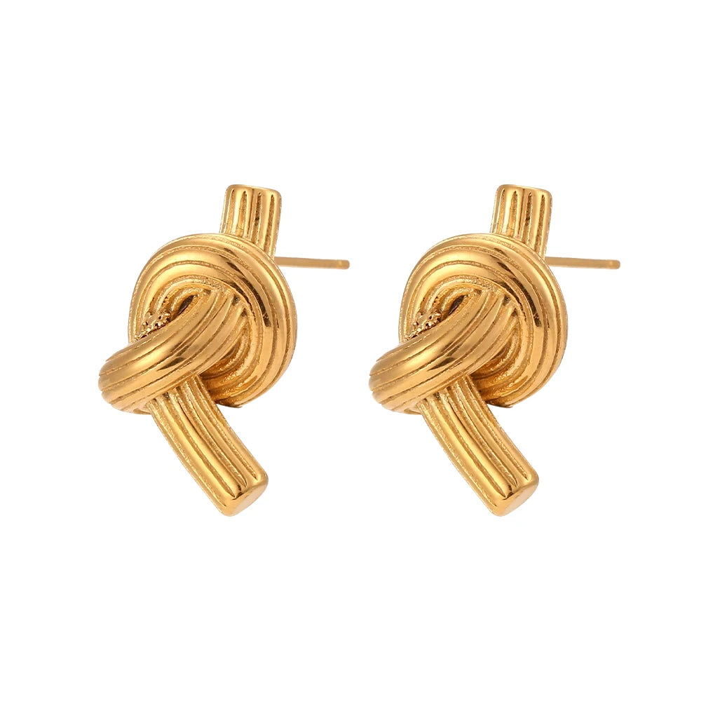 A pair of 18K gold plated stainless steel knot earrings with a textured surface.