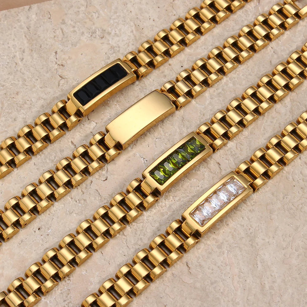 Stainless steel link bracelets with embedded gemstones on a beige surface