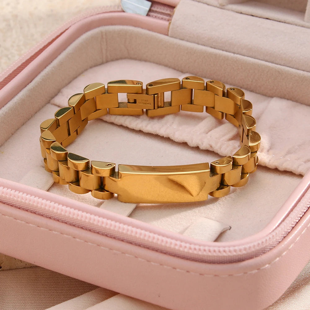 Gold steel link bracelet in a pink jewelry box