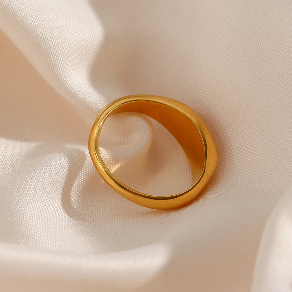 A stainless steel signet ring with a crystal embellishment, 