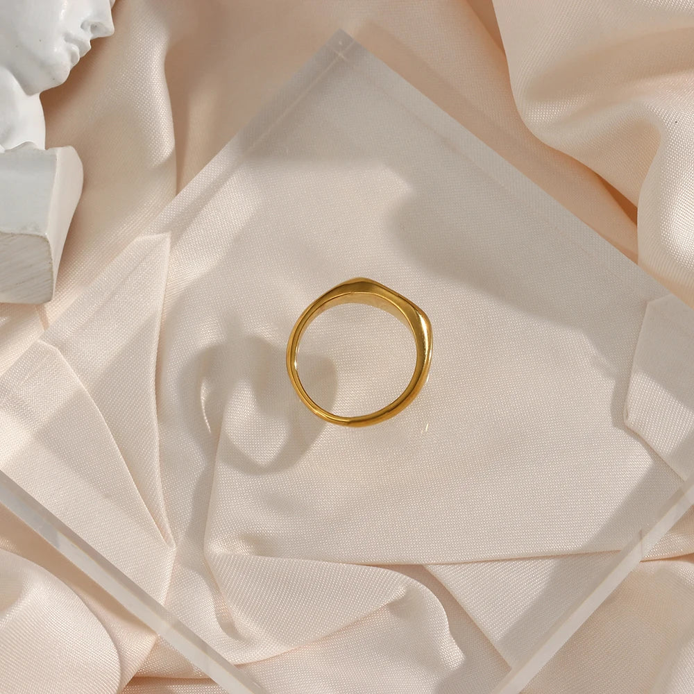 A stainless steel signet ring with a crystal embellishment, 