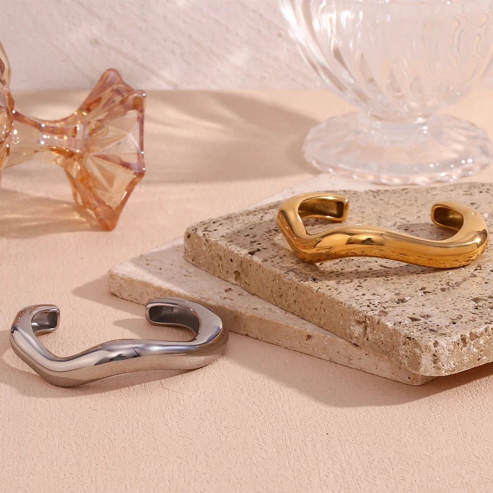 Sculpted Bangle Bracelet in gold and silver displayed