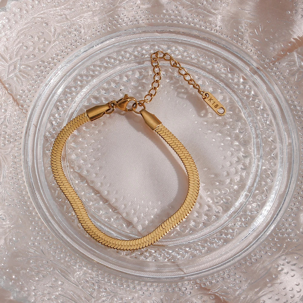 Sleek Line Snake Chain Bracelet gold flat lay on glass