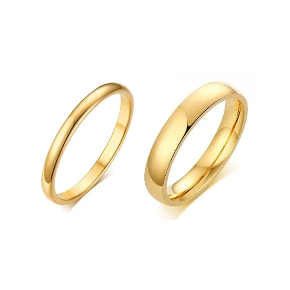 Two gold stainless steel wedding rings on a white background