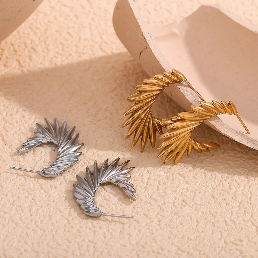 A pair of 18K gold plated stainless steel hoop earrings with a textured and spiky design.