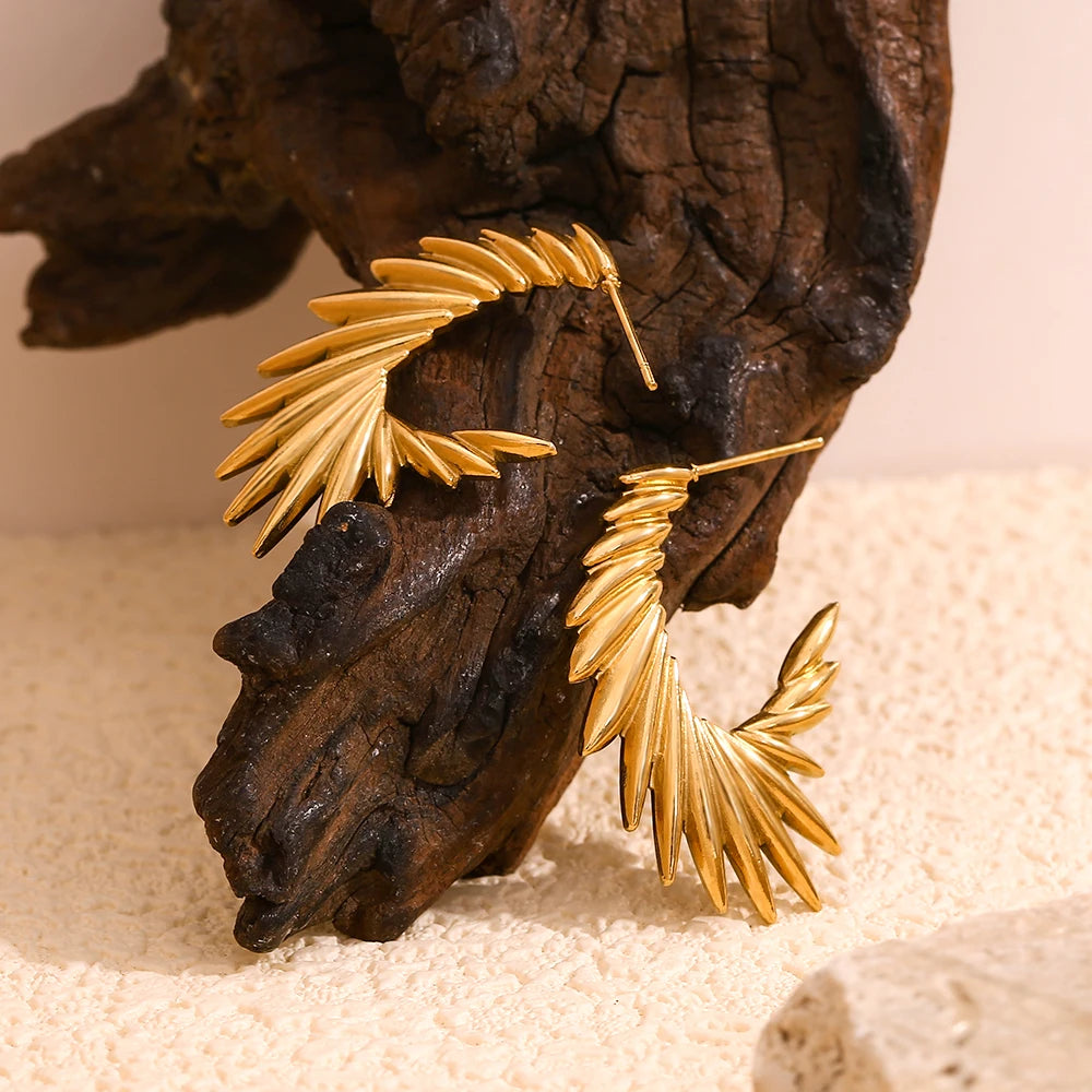 A pair of 18K gold plated stainless steel hoop earrings with a textured and spiky design.