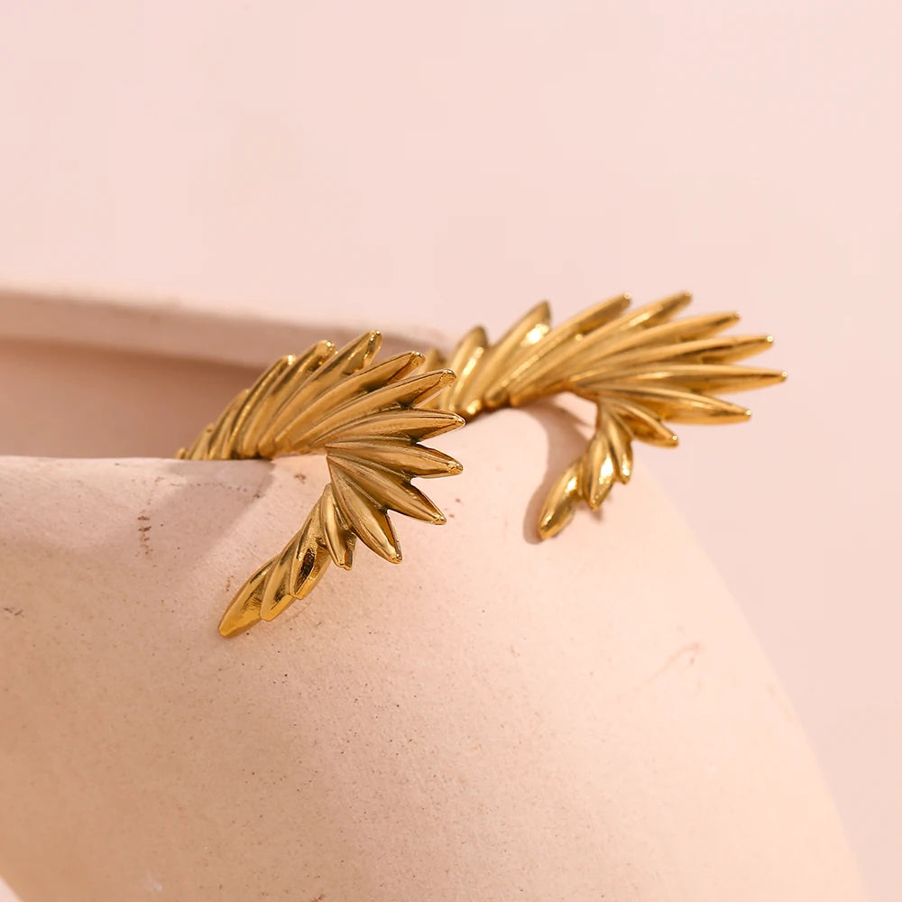 A pair of 18K gold plated stainless steel hoop earrings with a textured and spiky design.