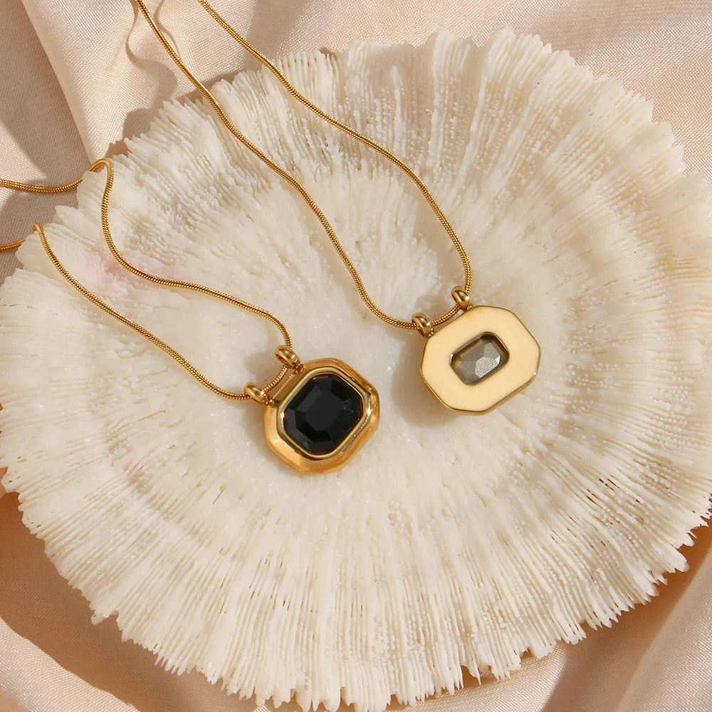 gold-plated stainless steel necklaces with a square-shaped AAA zirconia pendant, displayed in a white dish textured background