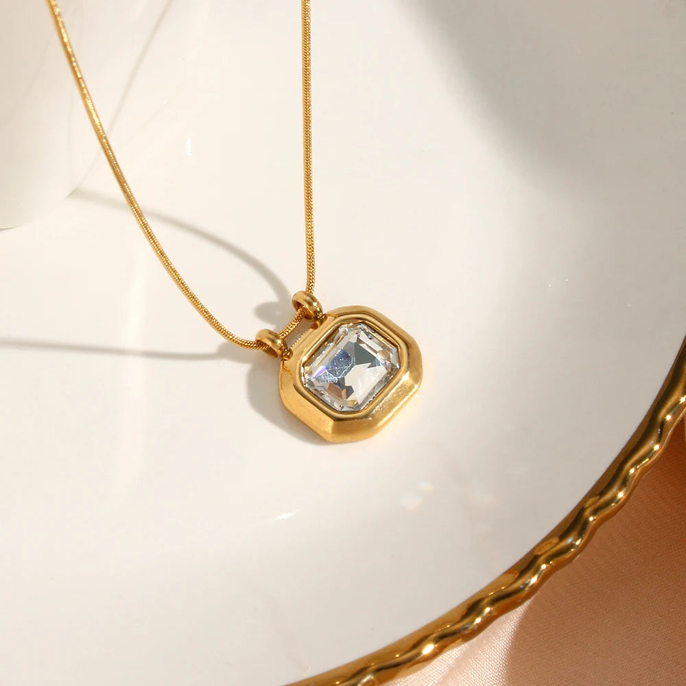 gold-plated stainless steel necklaces with a square-shaped AAA zirconia pendant, displayed in a white dish with a golden edge