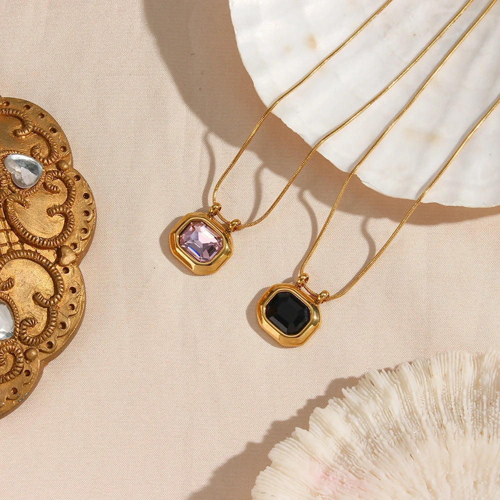 gold-plated stainless steel necklaces with a square-shaped AAA zirconia pendant, displayed on a textured beige background