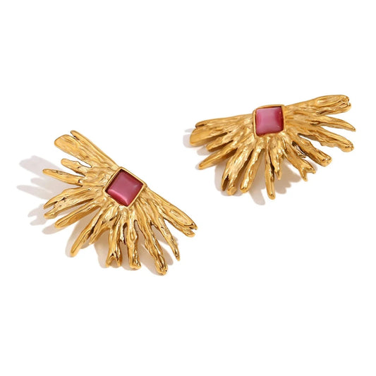 A pair of gold-colored earrings designed to resemble sun rays with a square pink gem at the top.