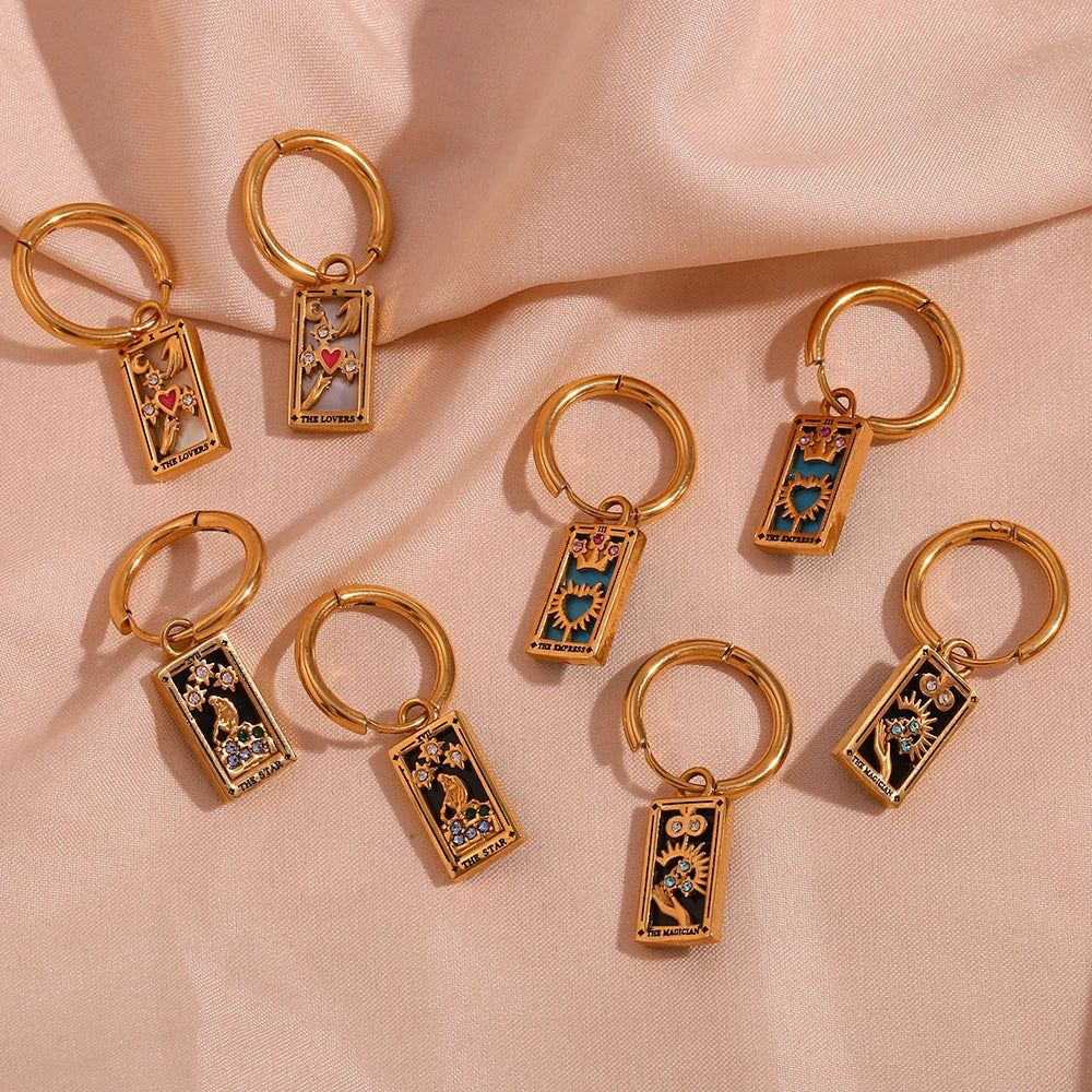 The Magician Tarot Card Earrings flat lay on fabric