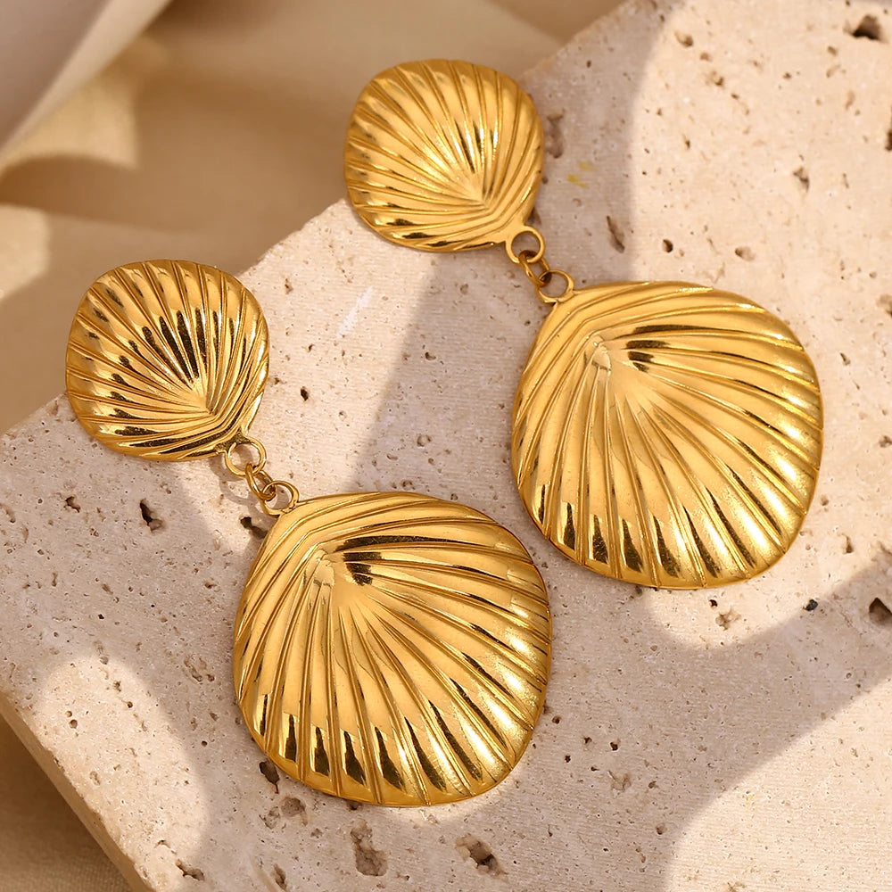 Tidal Grace Earrings on stone display