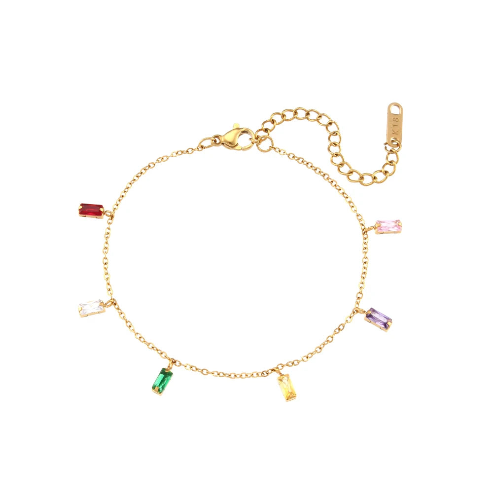 A golden bracelet with multicolored zirconia charms on a white background.