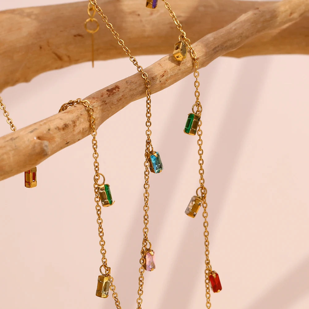 A golden bracelet with multicolored zirconia charms 