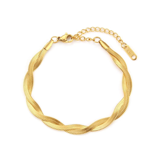 A gold twisted snake chain bracelet flat layed on a white background.