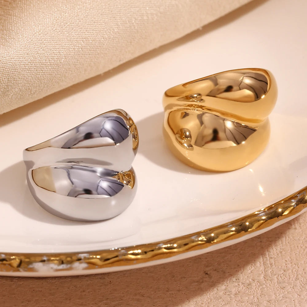 Gold and silver chunky stainless steel rings with a smooth, flowing design, symbolizing strength and connection.