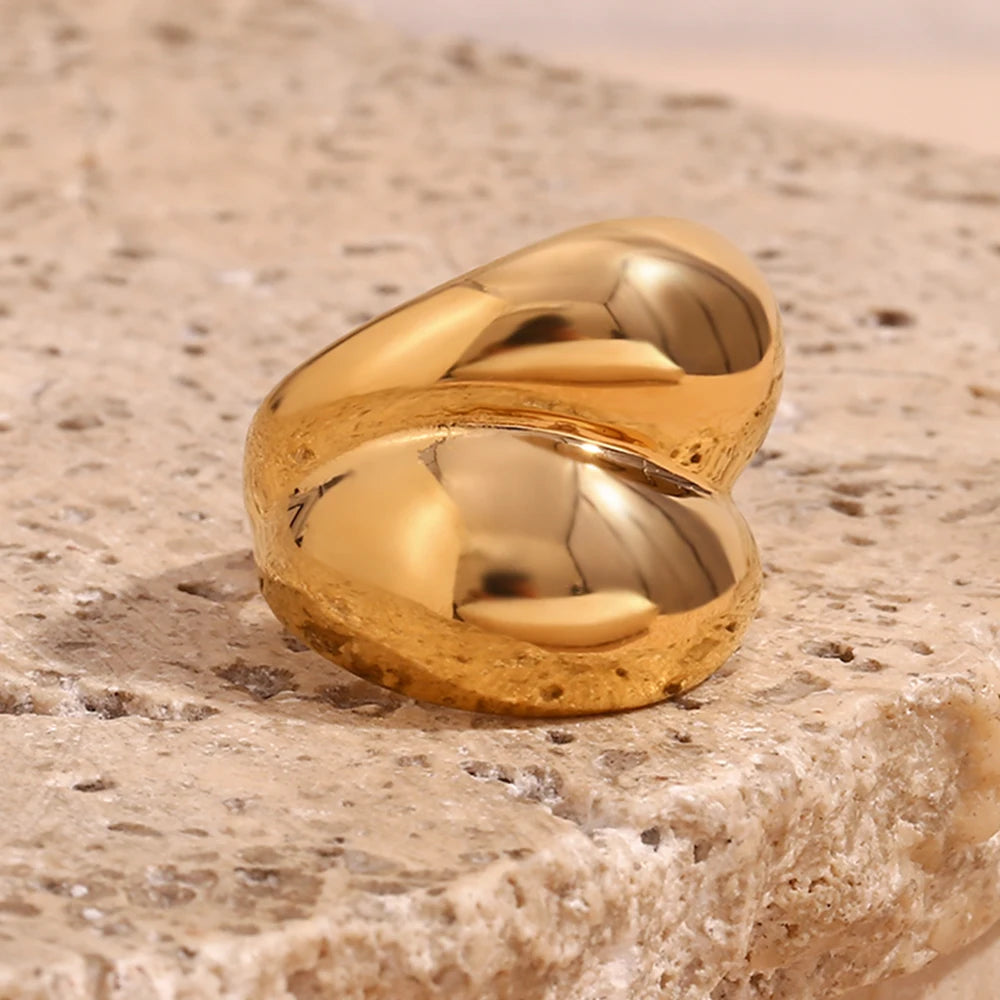 Gold chunky stainless steel ring with a smooth, flowing design, symbolizing strength and connection.