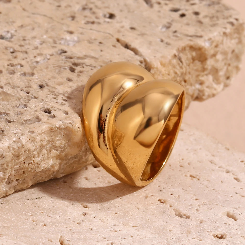 Gold chunky stainless steel ring with a smooth, flowing design, symbolizing strength and connection.