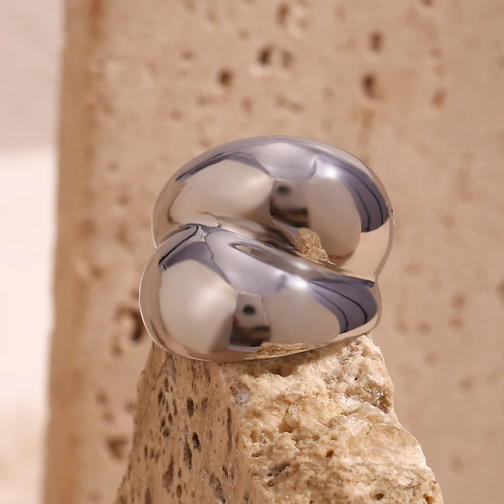 Silver chunky stainless steel ring with a smooth, flowing design, symbolizing strength and connection.