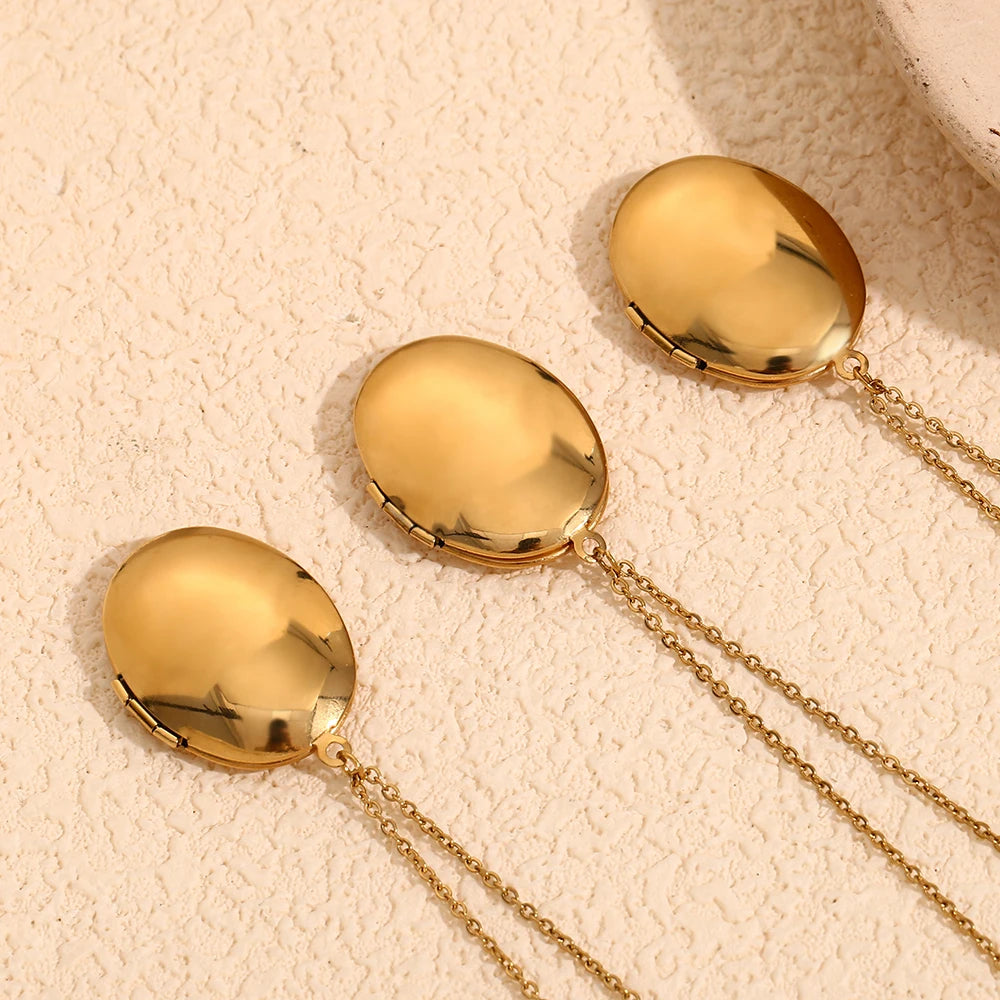 Oval-shaped gold-plated locket necklaces with vintage-inspired engravings, captured from backside