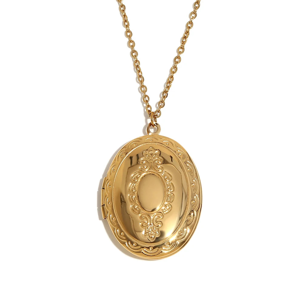 An oval-shaped gold-plated locket necklace with vintage-inspired engravings, attached to a gold chain.