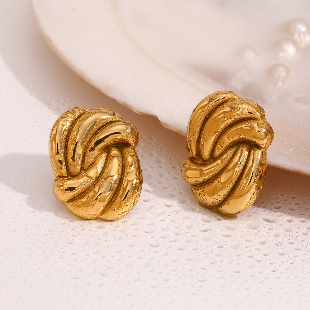 A pair of timeless gold earrings with a twisted design, crafted from 18K gold plated stainless steel wet